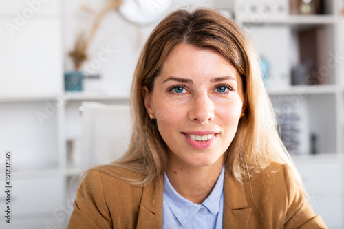 optimistic adult female person posing in white office