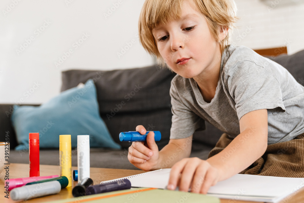 Concentrated little boy drawing at home Concentrated little boy drawing at home