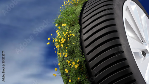 PKW Reifen. Gummibereifung. Alufelgen. Auf der Hälfte des Autoreifens wachsen Gräser und Blumen. Konzept: Nachhaltigkeit, Ökologie, Ressourcenschonung, Umweltverträglichkeit, Rohstoffe, Greenwashing