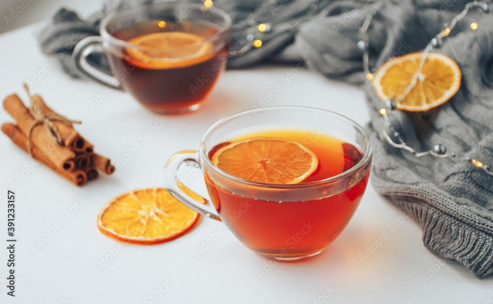 Cup of tea with lemon and cinnamon on white table. Cozy autumn composition Cup of tea with lemon and cinnamon on white table. Cozy autumn composition