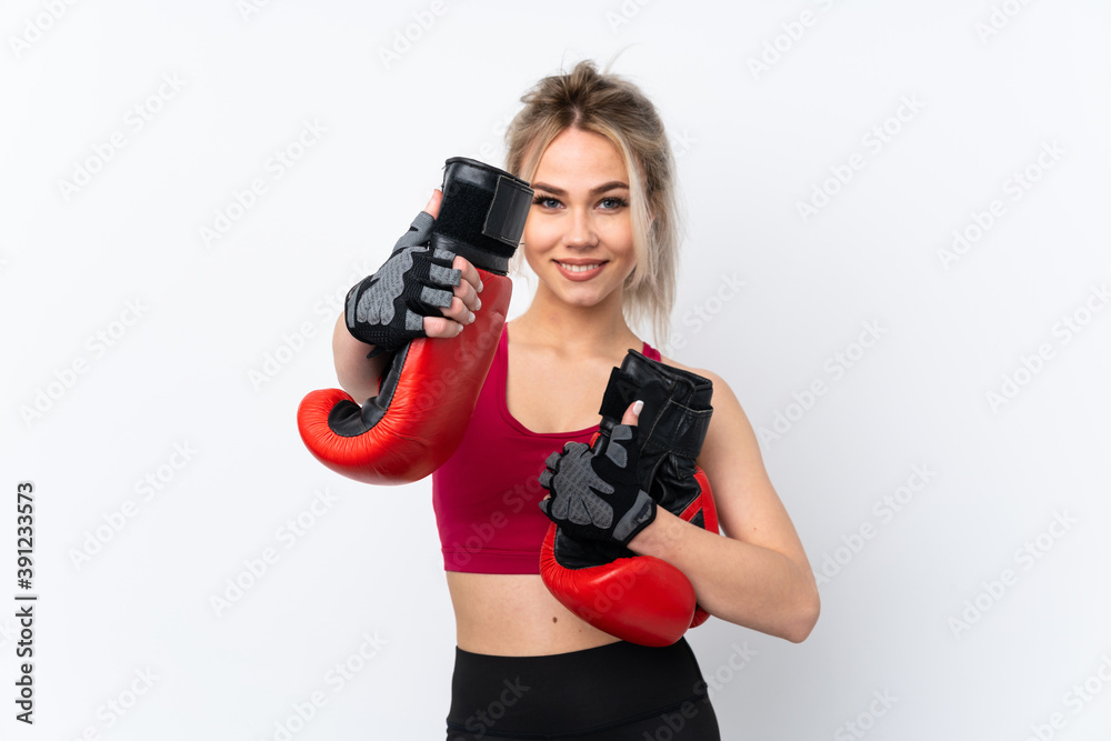 Teenager girl holding waffles over isolated blue background with boxing gloves Teenager girl holding waffles over isolated blue background with boxing gloves