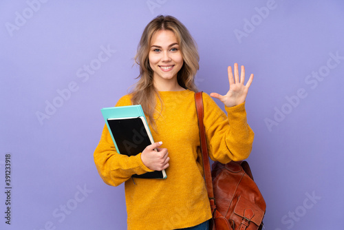 Teenager Russian student girl isolated on purple background counting five with fingers