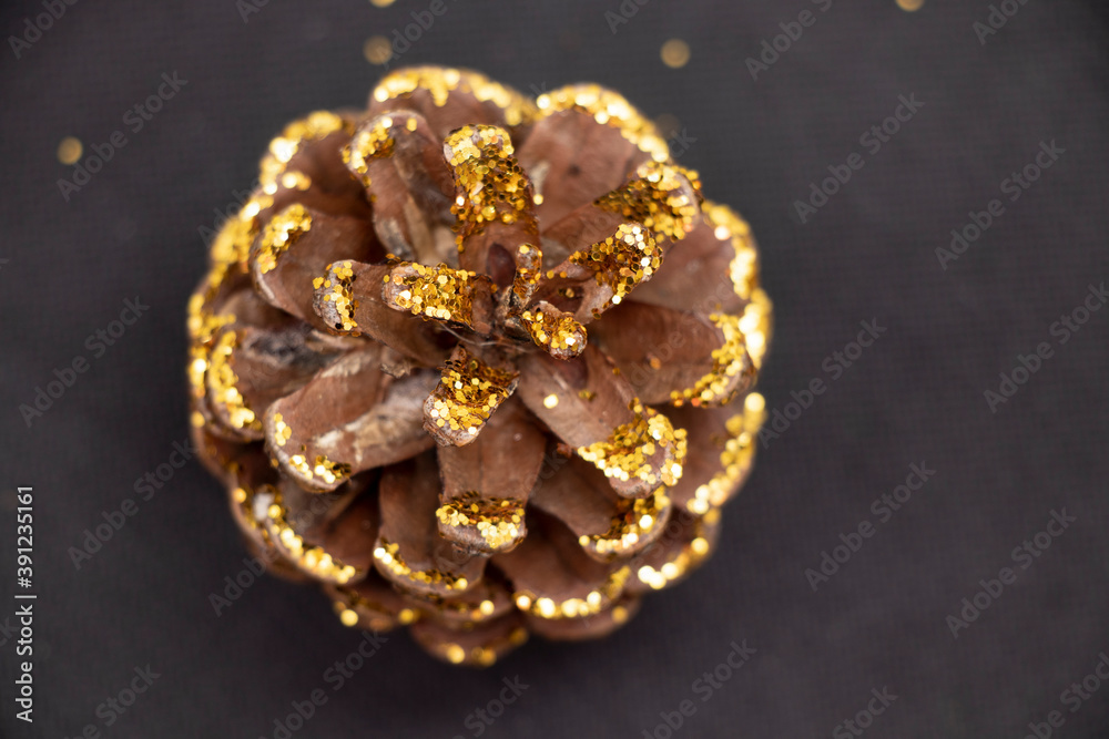 Cones covered with sparkles on a black background. Holidays. Cones covered with sparkles on a black background. Holidays.
