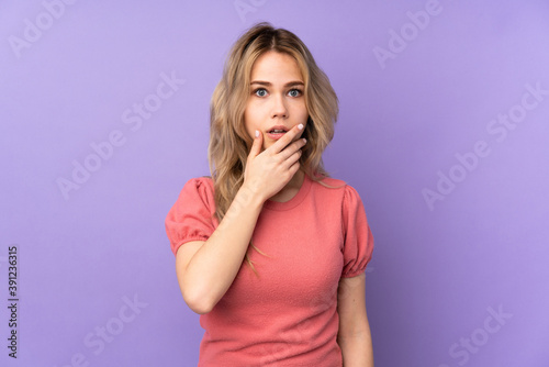 Teenager Russian girl isolated on purple background surprised and shocked while looking right