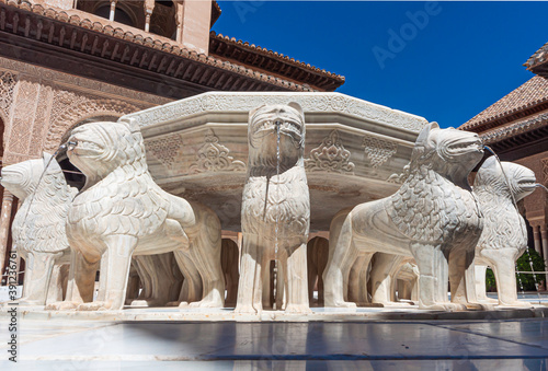 Splendid Lion fountain in Court of Lions (Nasrid Palace, Alhambra), surrounded by complex arcade with muqarnas arches and sebka decors,
