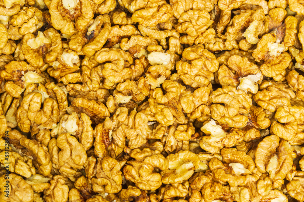 Peeled walnuts background. Used as useful additive in cooking