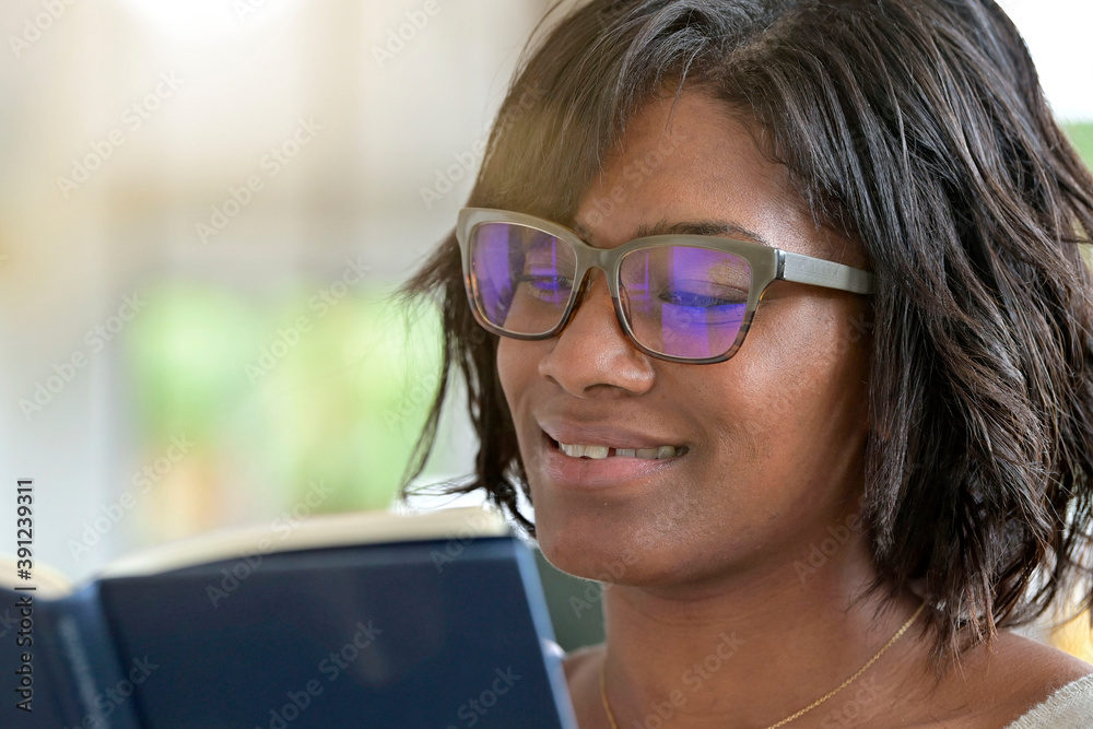 Portrait of african american woman reading book with eyeglasses Portrait of african american woman reading book with eyeglasses