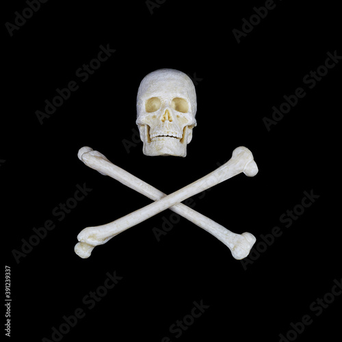 Black human skull with red glowing eyes and crossed bones on a white background, a sign stop, be careful, dangerous.