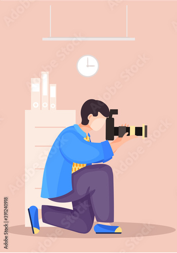 The guy sitting and adjusting the camera. Photographic art. A man prepares camera for a photo shoot. Photographer with camera takes picture in the library. Book storage, Room with bookcases