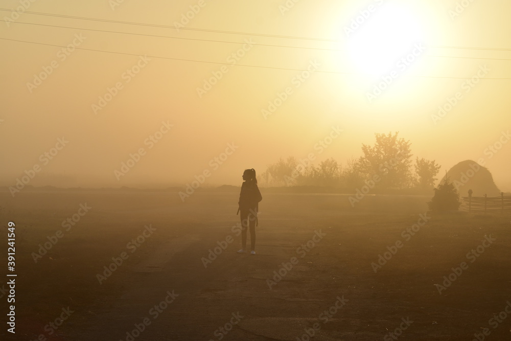 person walking in the fog