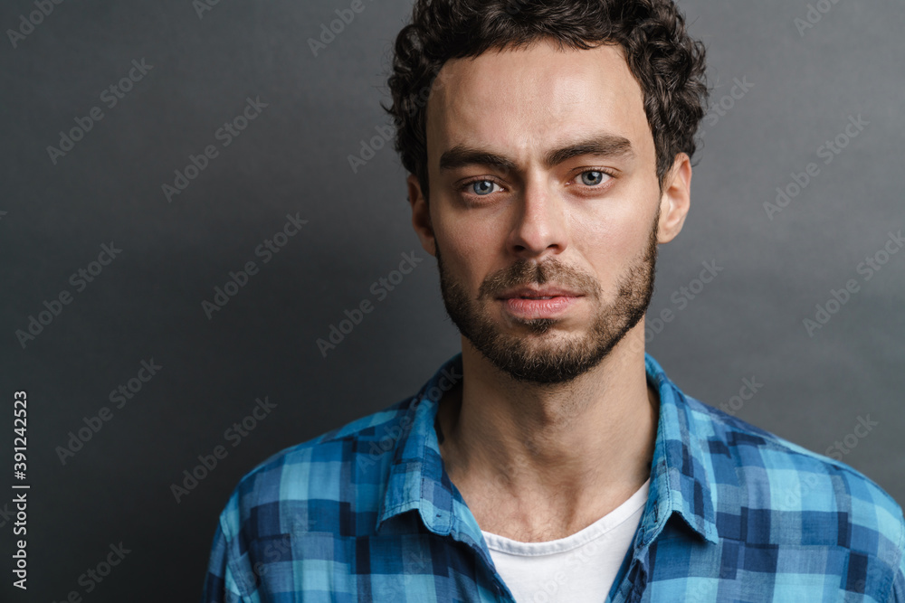 Unshaven handsome guy posing and looking at camera Unshaven handsome guy posing and looking at camera