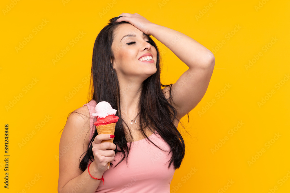 Young Colombian girl holding an cornet ice cream over isolated yellow background has realized something and intending the solution Young Colombian girl holding an cornet ice cream over isolated yellow background has realized something and intending the solution