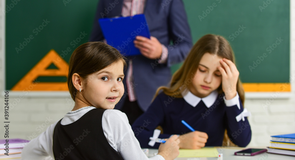 Focused and concentrated students. Control process. Testing students. Pedagogue. Watching them. Teacher and kids Classroom. Daily school life. Back to school. Help and support. Children and teacher Focused and concentrated students. Control process. Testing students. Pedagogue. Watching them. Teacher and kids Classroom. Daily school life. Back to school. Help and support. Children and teacher