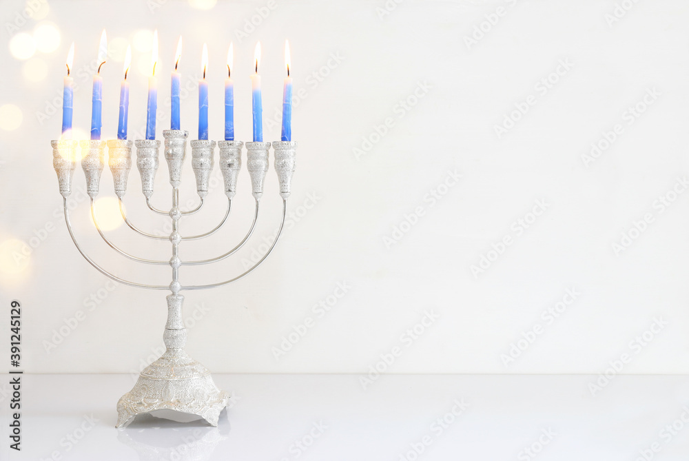 Religion image of jewish holiday Hanukkah background with menorah (traditional candelabra) and candles