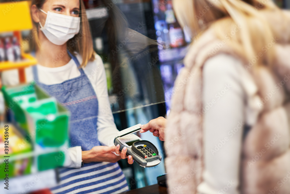Adult woman in medical mask shopping for groceries Adult woman in medical mask shopping for groceries