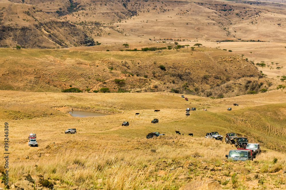 Harrismith, South Africa - October 03, 2015: Jeep 4x4 Vehicles on a Dirt Road in the Drakensberg Harrismith, South Africa - October 03, 2015: Jeep 4x4 Vehicles on a Dirt Road in the Drakensberg