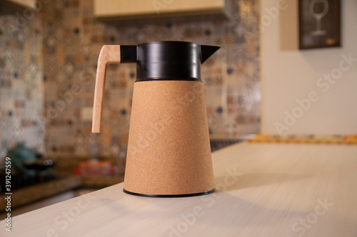 Foto Coffee thermos bottle with cup, placed on the counter of a Brazilian kitchen