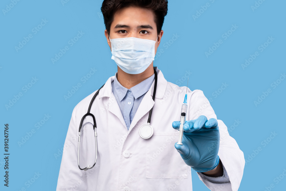 Male doctor holding syringe with virus vaccine Male doctor holding syringe with virus vaccine