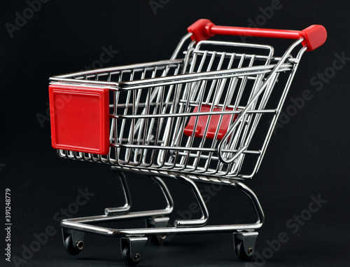 Empty shopping cart on black background