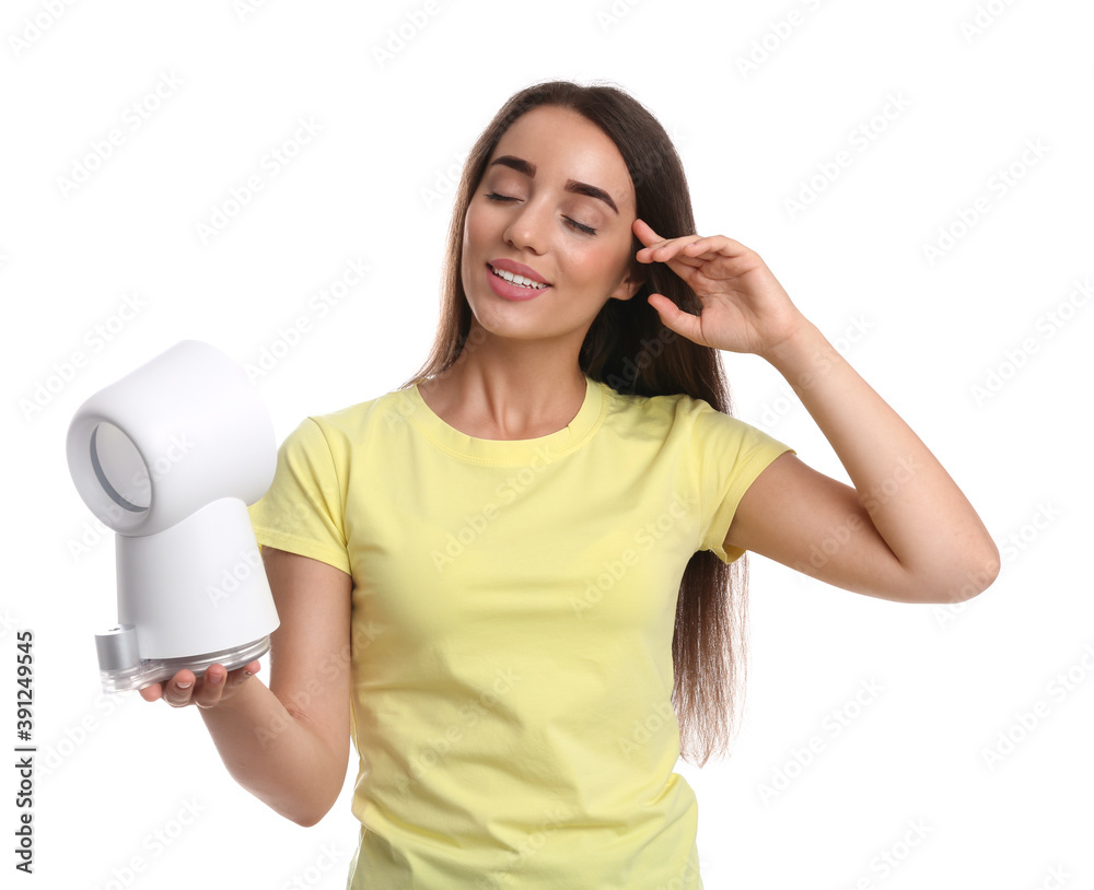 Naklejka premium Woman enjoying air flow from portable fan on white background. Summer heat