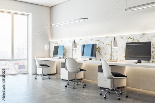 Coworking office interior with three computers