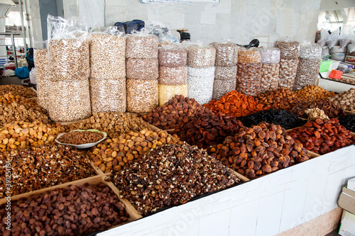 Dried apricots and various nuts in bags and boxes at the Chorsu market in Tashkent, Uzbekistan. photo