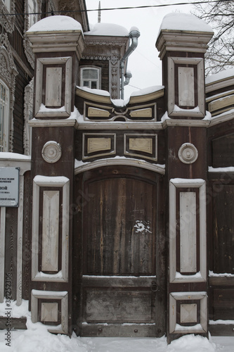 Gate, door of Moskov's old wooden house with carved windows in Tatarskaya Street, 46, Tomsk city, Russia. Russian style in architecture. Tomsk landmark, monument, view photo