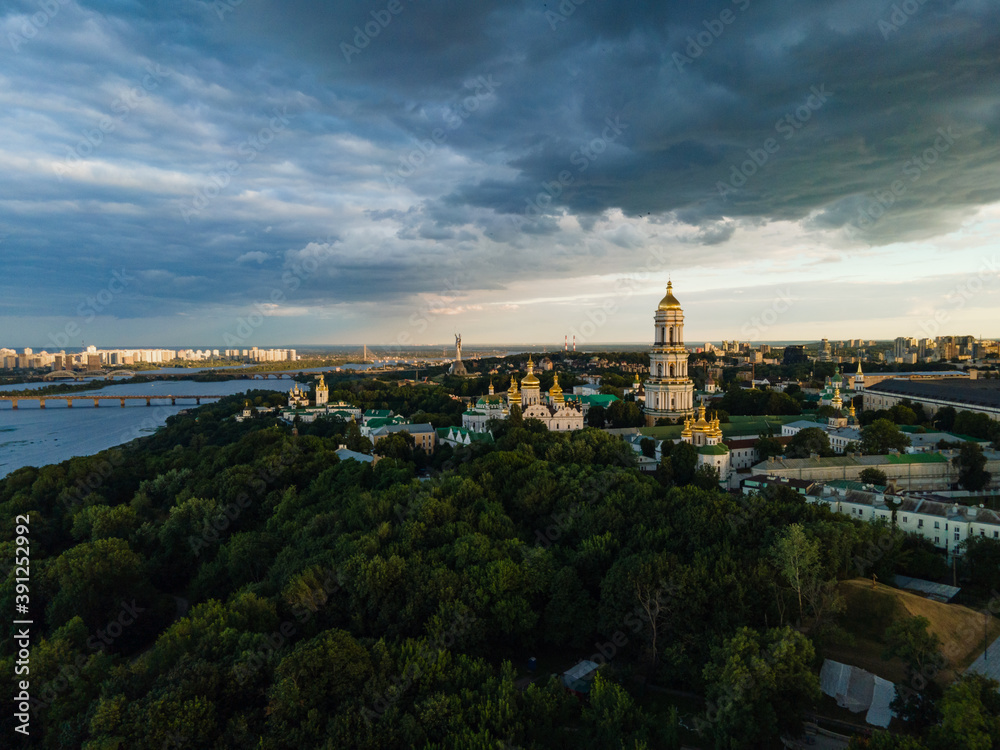 Aerial evening view to the Kyiv Pechersk Lavra monastery. Stormy golden hour