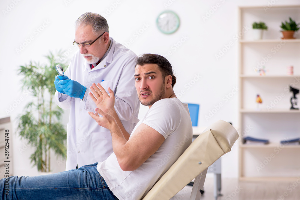 Young man visiting experienced doctor dermatologist Young man visiting experienced doctor dermatologist