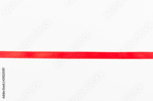 Top view of Red ribbon isolated shiny rolled on white background. Flat lay view. Free Download Top view of Red ribbon isolated shiny rolled on white background. Flat lay view. - GFXLoad