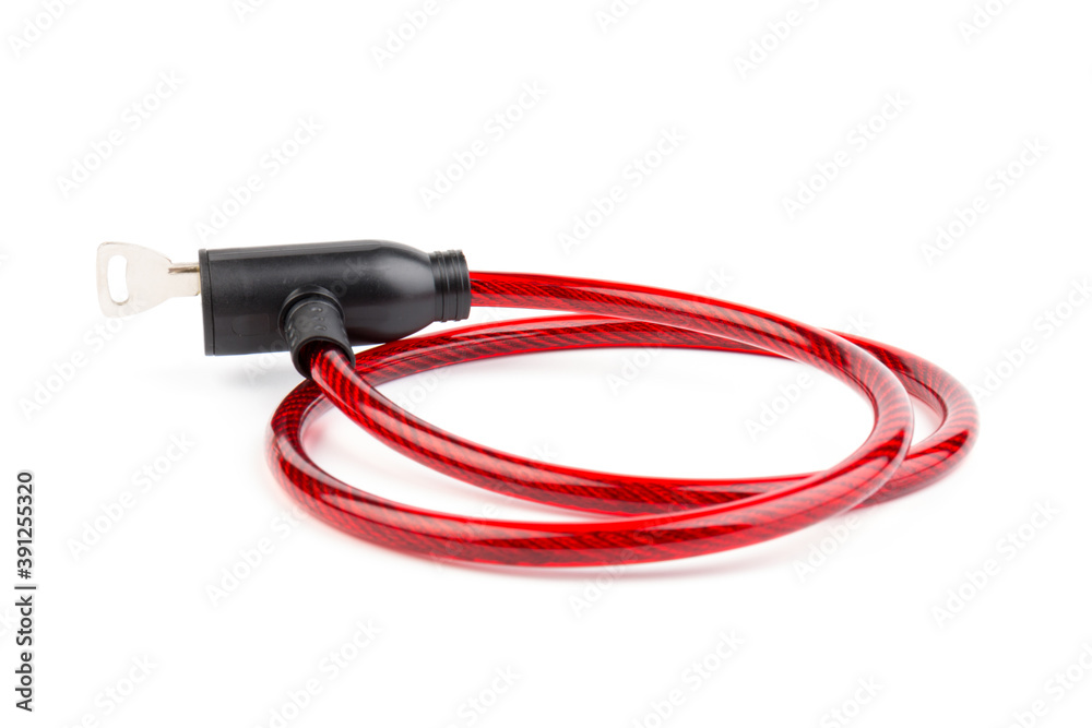Flexible red bicycle cable with key on white background. Security and safety concept. Flexible red bicycle cable with key on white background. Security and safety concept.