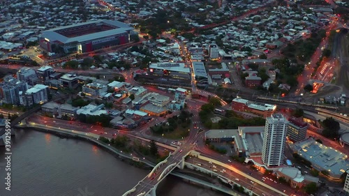 Cars Driving At M3 Motorway And William Jolly Bridge Overlooking The Suncorp Stadium And Roma Street Railway Station At Night In Brisbane CBD, Queensland, Australia. - aerial drone shot photo