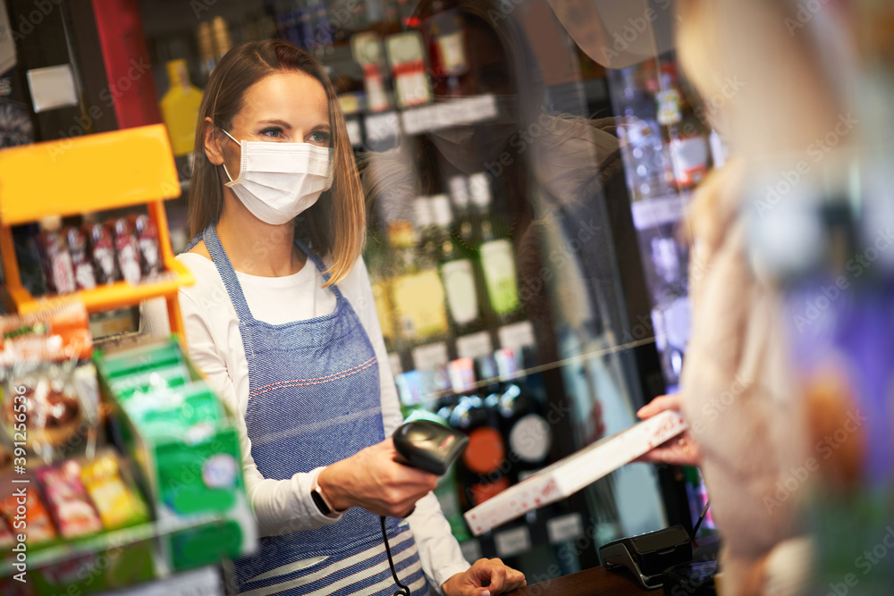Adult woman in medical mask shopping for groceries