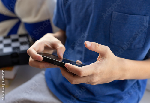 childrens hands with mobile phone playing video games. Technology  internet and people concept. close-up