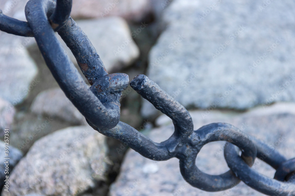 The broken link of an old rusty nautical chain. The broken link of an old rusty nautical chain.
