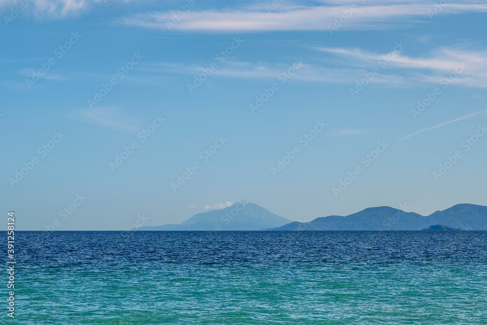 Blue background with mountains and sea