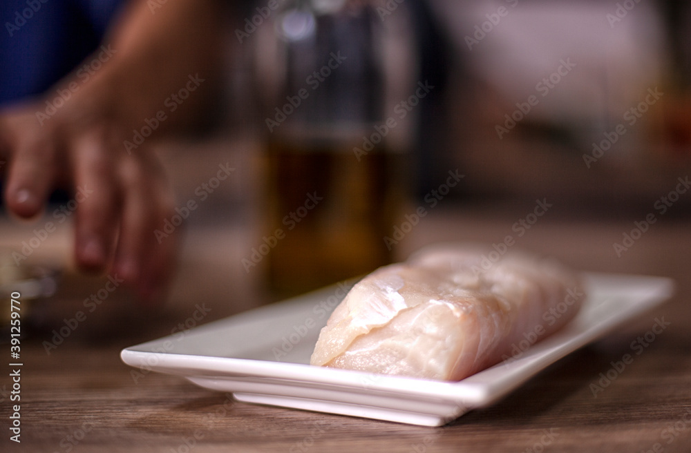 close-up of raw fish and dishes cooked at home kitchen