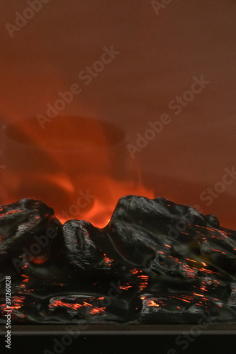 Small decorative fireplace with various sweets and reflections