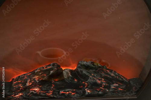 Small decorative fireplace with various sweets and reflections