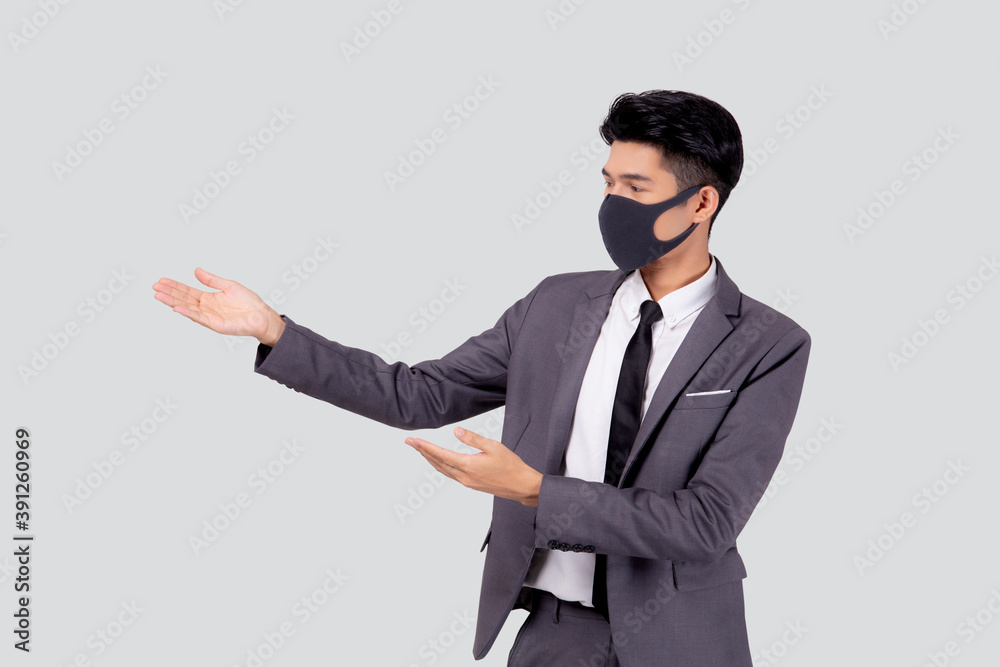 Portrait young asian businessman in suit wearing face mask for protective covid-19 isolated on white background, business man presenting and showing, quarantine for pandemic coronavirus, new normal. Portrait young asian businessman in suit wearing face mask for protective covid-19 isolated on white background, business man presenting and showing, quarantine for pandemic coronavirus, new normal.