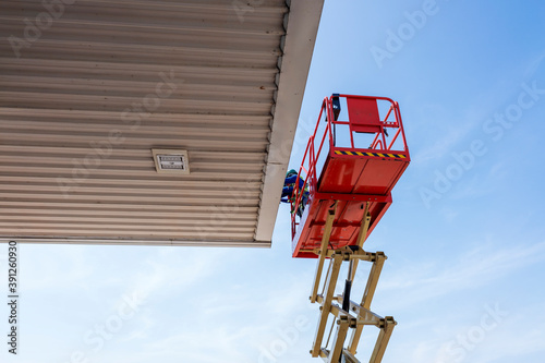 Worker on a Scissor Lift Platform working at site
