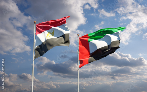 Beautiful national state flags of Egypt and UAE United Arab Emirates together at the sky background. 3D artwork concept. © Leo Altman