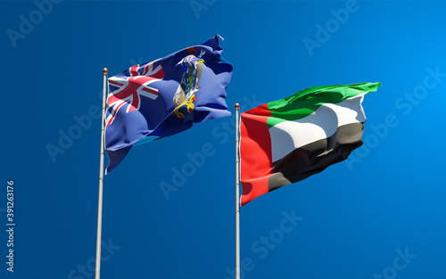 Beautiful national state flags of South Georgia and the South Sandwich Islands and UAE United Arab Emirates together at the sky background. 3D artwork concept.