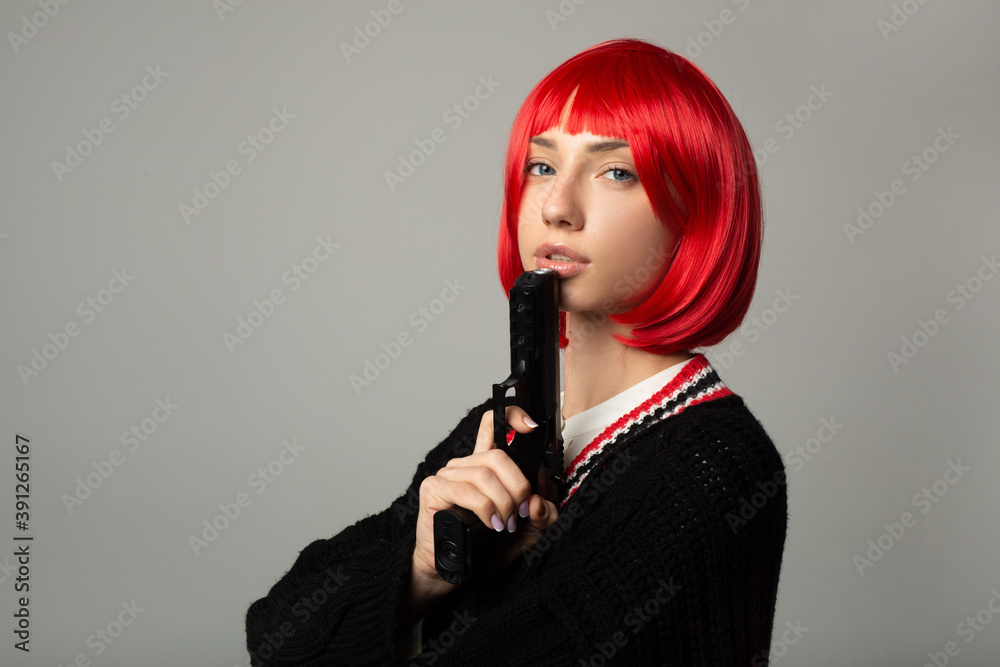 beautiful young female with red hair with a gun