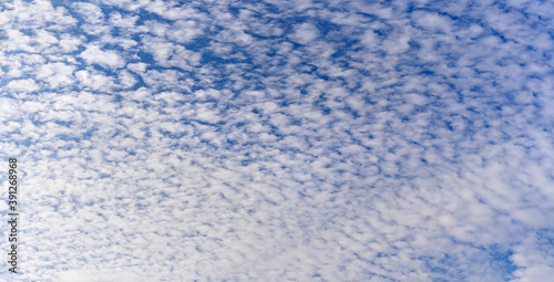 White little cumulus clouds on the blue sky