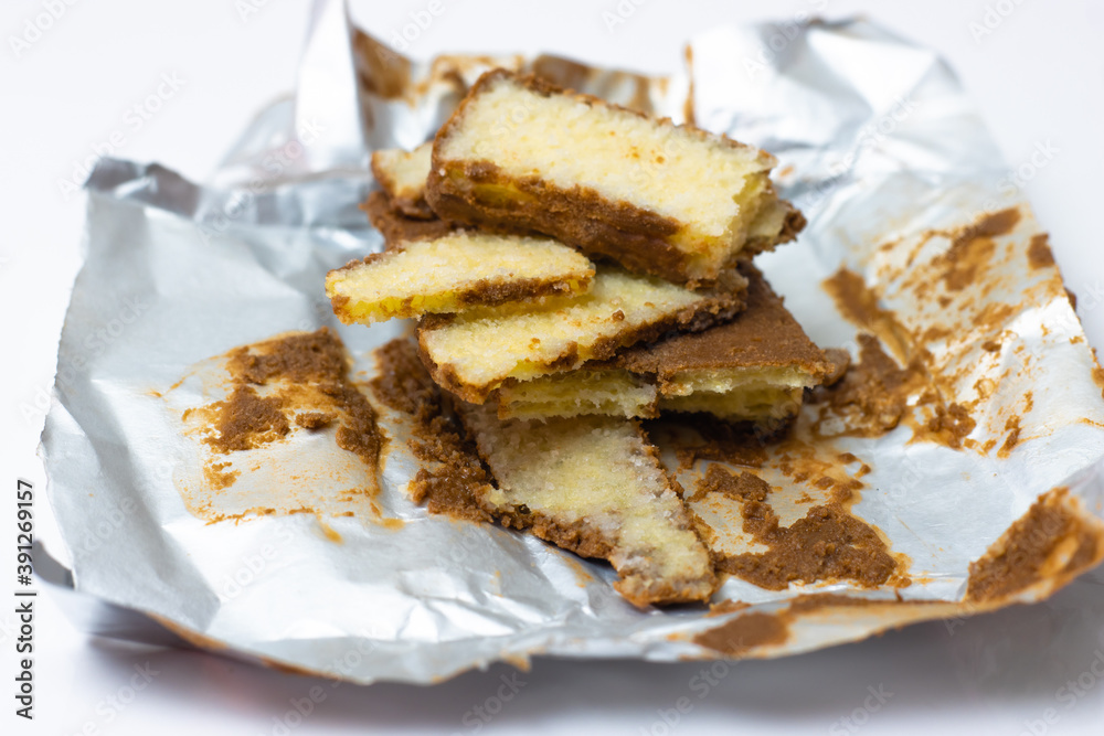 A closeup look of broken cake biscuits on isolated white background A closeup look of broken cake biscuits on isolated white background