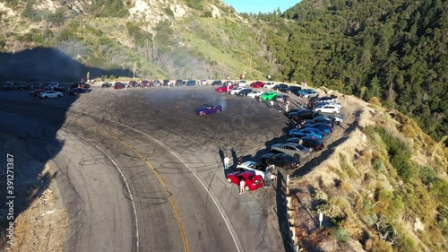 Done shot of muscle and sports cars doing doughnuts and burnouts with a car club in the Angeles National Forest in Southern California
