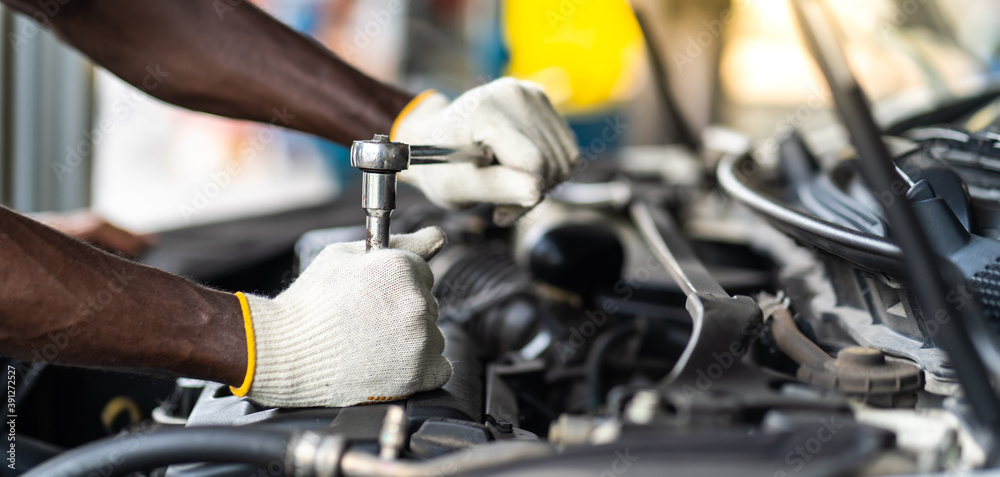 Hands Expertise car mechanic in auto repair service. Car maintenance and auto service garage concept. Hands Expertise car mechanic in auto repair service. Car maintenance and auto service garage concept.