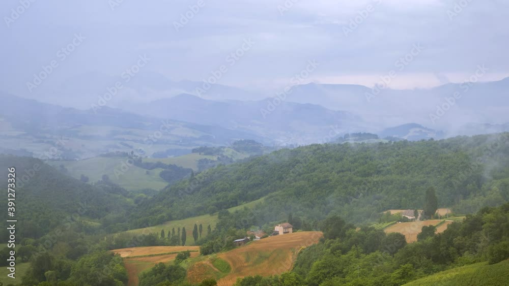 Rain clouds fog timelapse moving towards the camera over rural field hills in Italy, nature outdoor landscape panorama view. Green grass, rainy natural scenery. High quality 4k footage Rain clouds fog timelapse moving towards the camera over rural field hills in Italy, nature outdoor landscape panorama view. Green grass, rainy natural scenery. High quality 4k footage