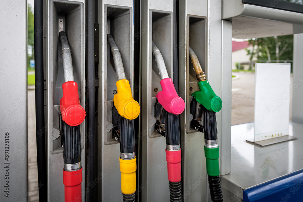 pistols with different fuels at the gas station pistols with different fuels at the gas station